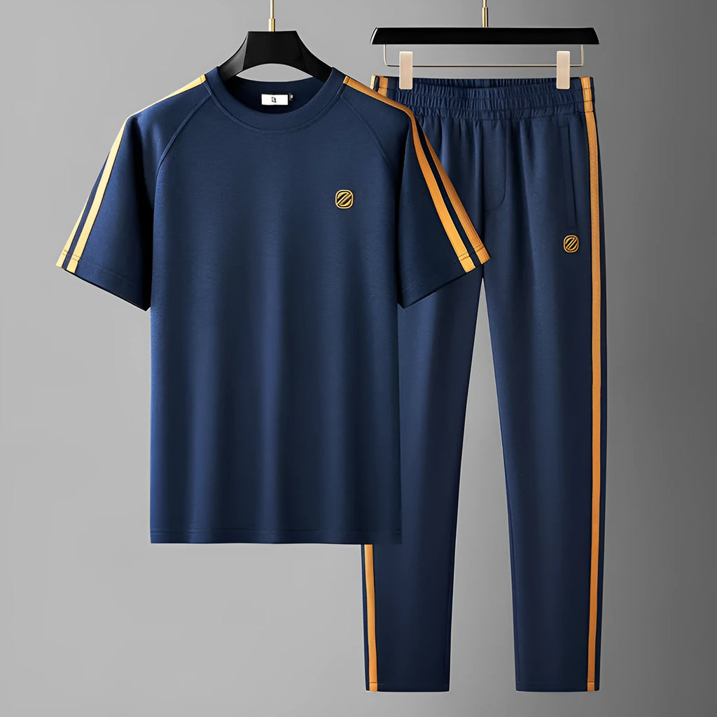 Man wearing a blue ice silk style short sleeve tracksuit set, showing the top and pants.