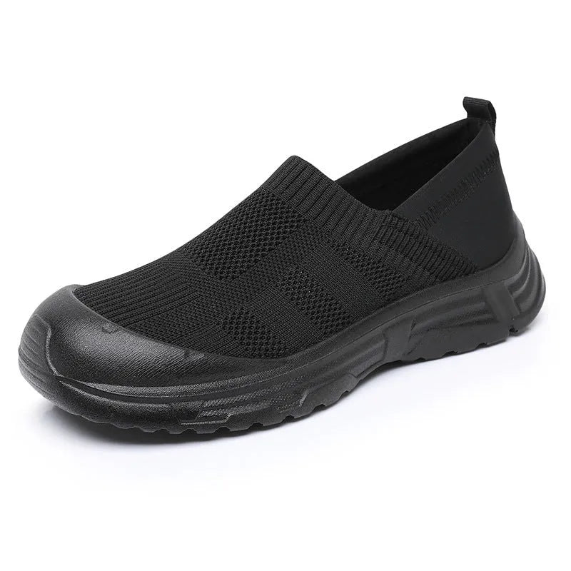 Women's black slip-on cloth shoes with a flat PVC sole and round toe design.