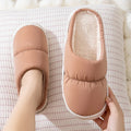 A pair of down cotton indoor slippers with a thick rubber sole and plush lining, shown in a choice of colours.