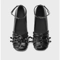 Women's black patent leather square-toe pumps with a buckle strap and flat rubber sole.