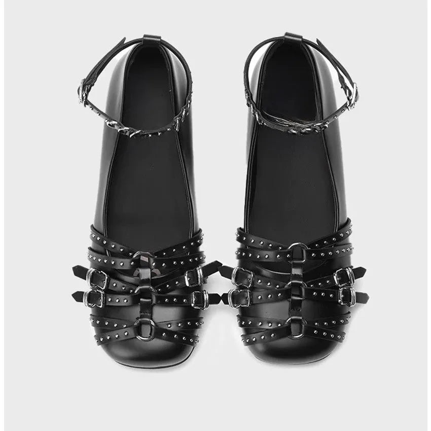 Women's black patent leather square-toe pumps with a buckle strap and flat rubber sole.