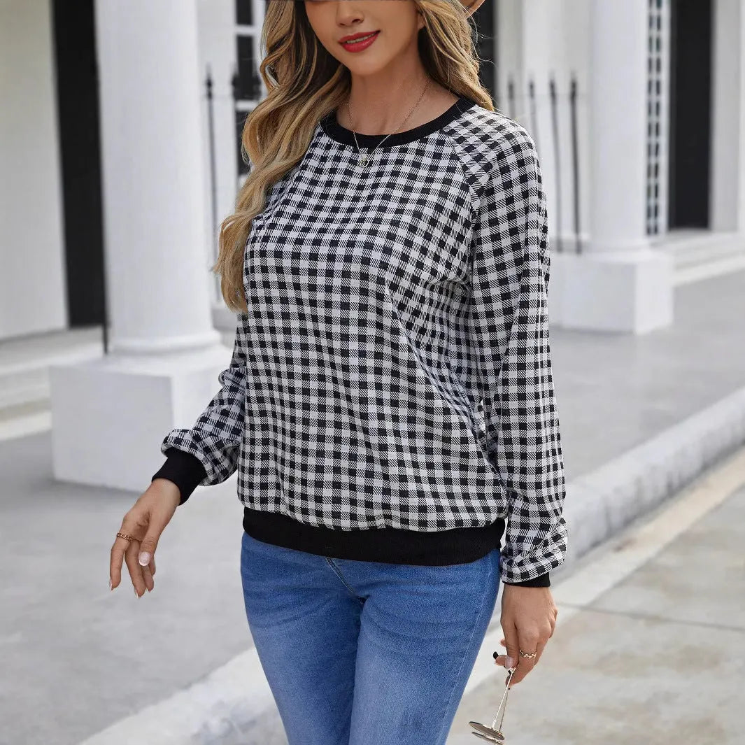 Black polyester pullover sweater with a plaid and printed stripe pattern, long sleeves.