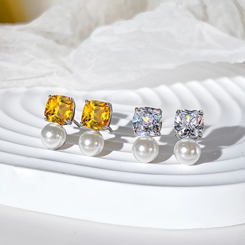 Sterling silver earrings with diamond-shaped zirconium inlay and pearl centre