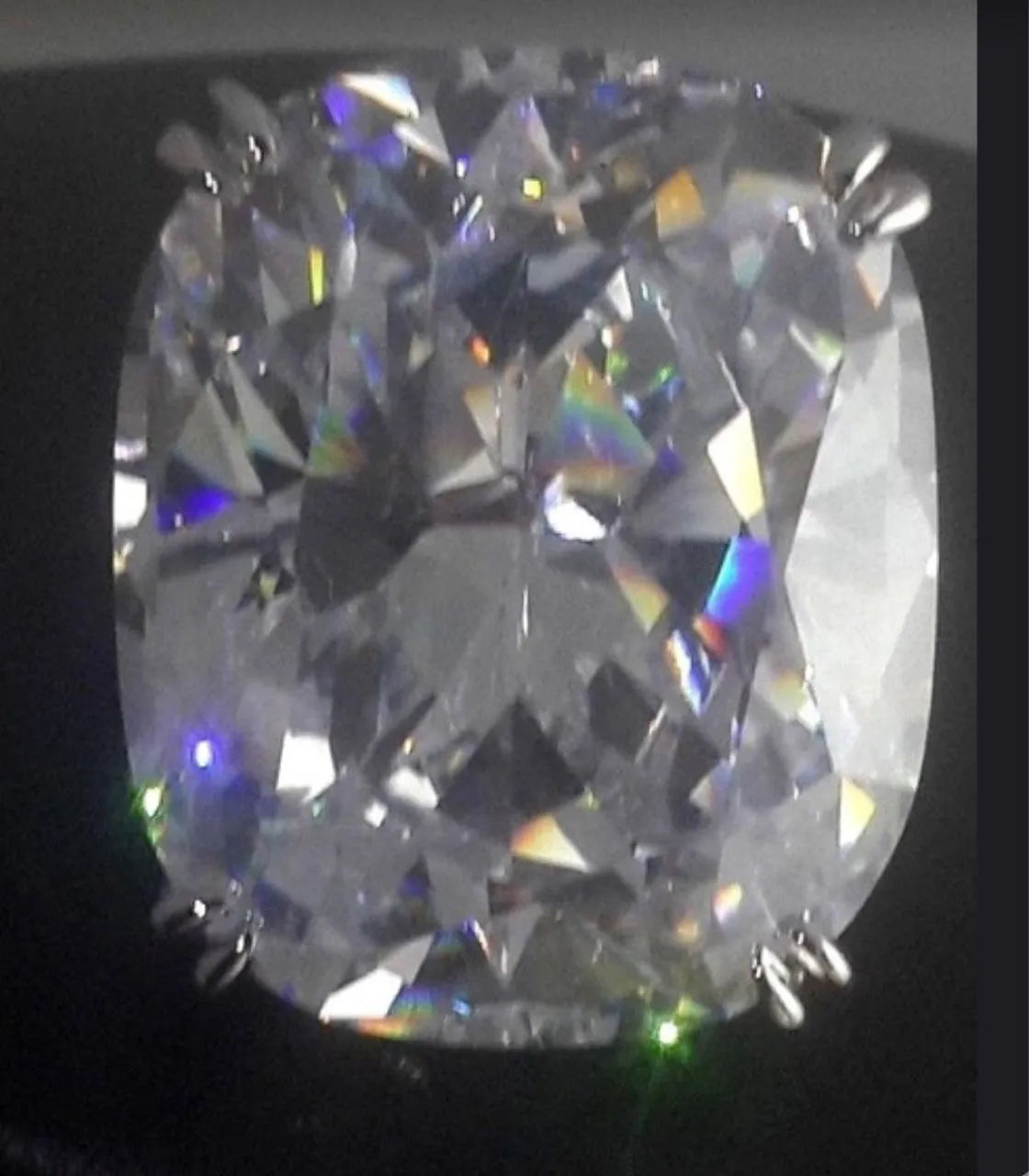 Simple women's alloy ring with an inlaid square diamond design in white gold colour on a model's finger.