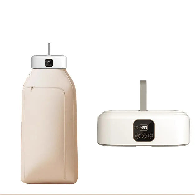 White foldable cylindrical laundry dryer with remote control on a table.