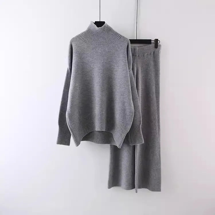 Women's beige acrylic sweater and wide-leg trousers two-piece set laid flat.