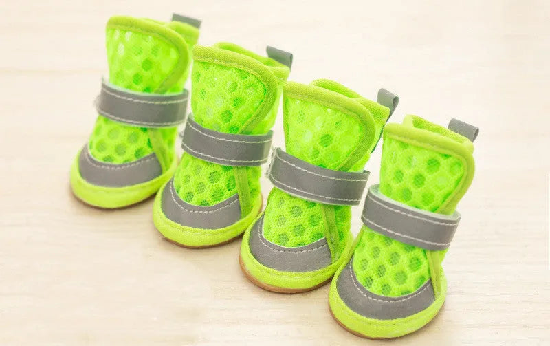 Set of four small dog rubber shoes in blue, red, orange, green for non-slip paw protection