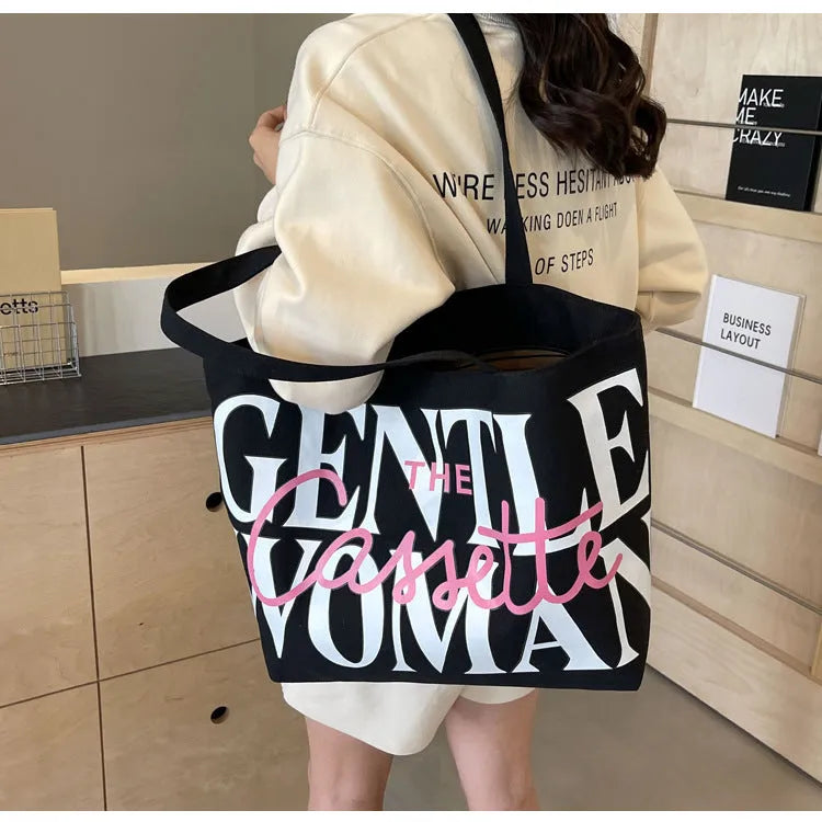 Canvas tote bag with letter print and car stitching detail in medium size 40x7x32cm available in black