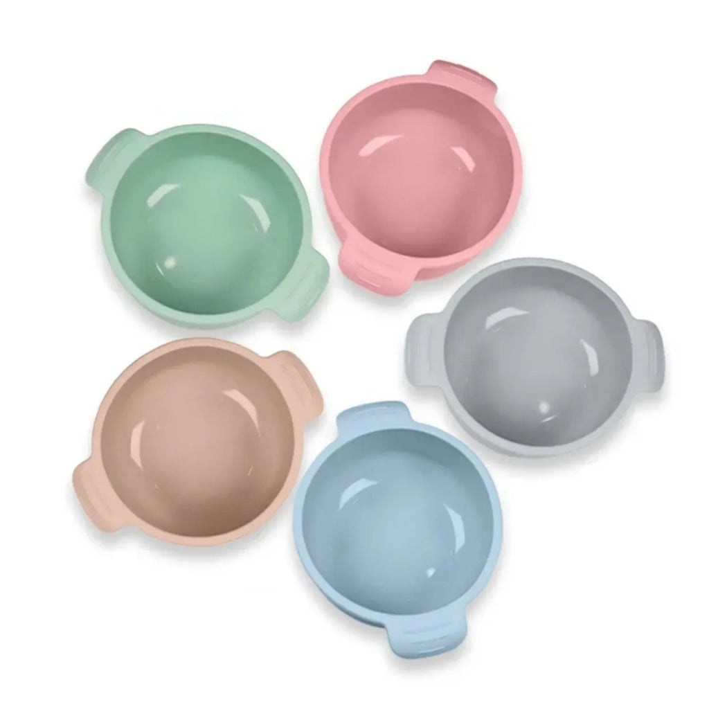 Blue silicone pet bowl with a suction cup base on a smooth floor