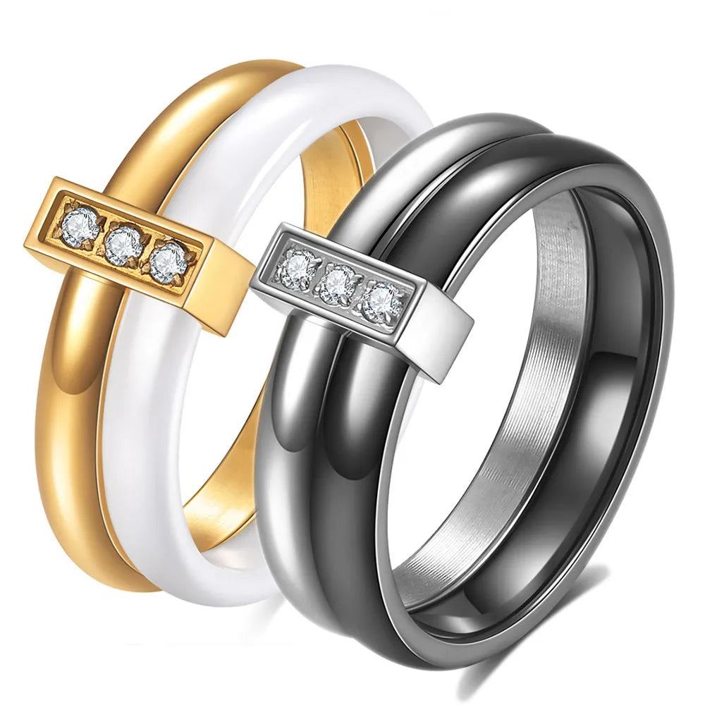 Close-up of a women's geometric ceramic ring with a 6mm wide band and glossy stitching detail, shown in a gold white electroplated finish.