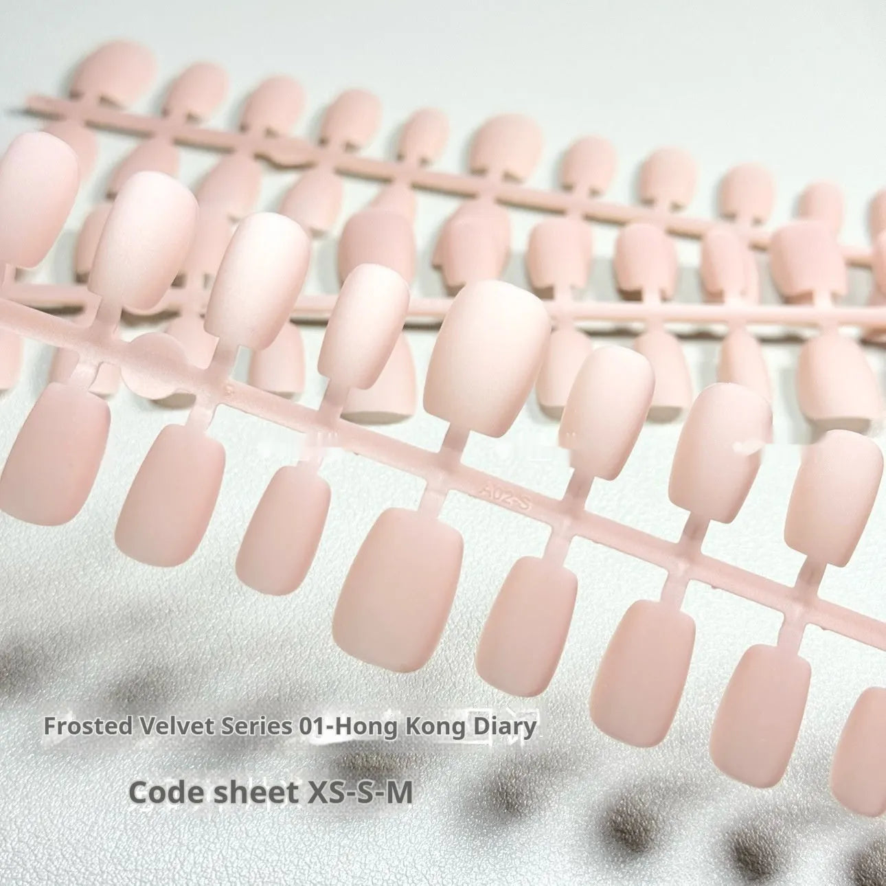 Frosted Velvet Cat's Eye artificial nail set in short ladder sizes on a display card.