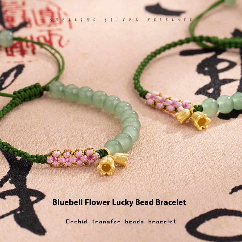 Red rope hand woven women's bracelet with floral elements in national style