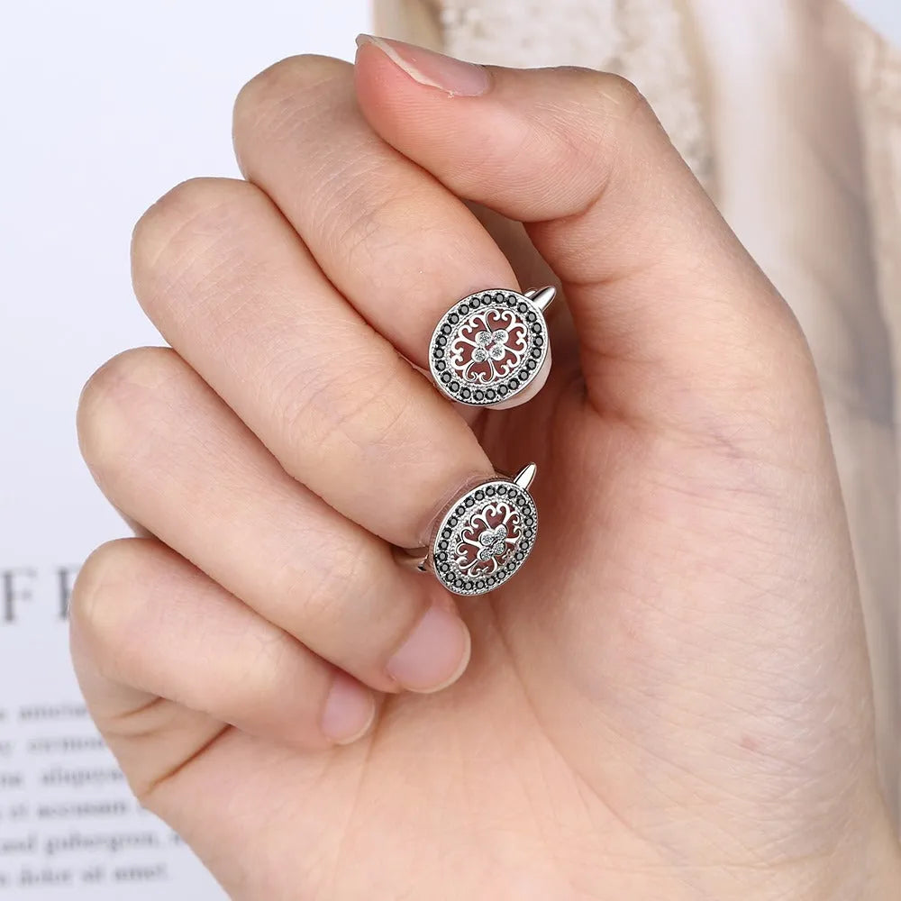 Pair of round diamond-encrusted ear clip earrings in copper white gold plated platinum colour