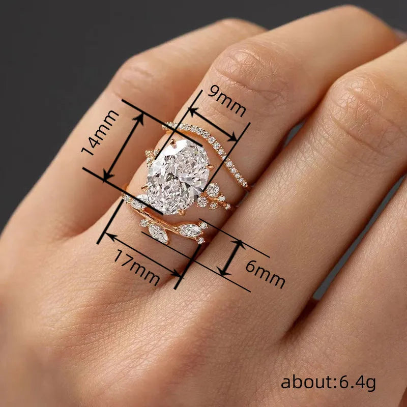 Copper zircon ring set with goose egg-shaped cut in Q681 gold on hand, three rings with flower and geometry shapes