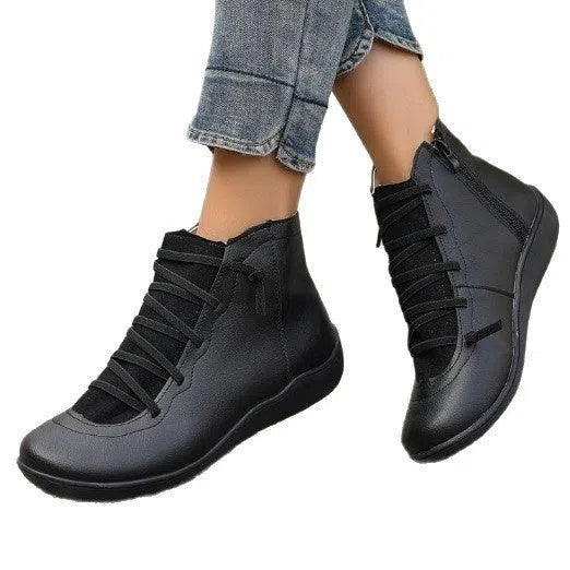 Women's plus size flat side zipper short boots in black with round toe and low heel