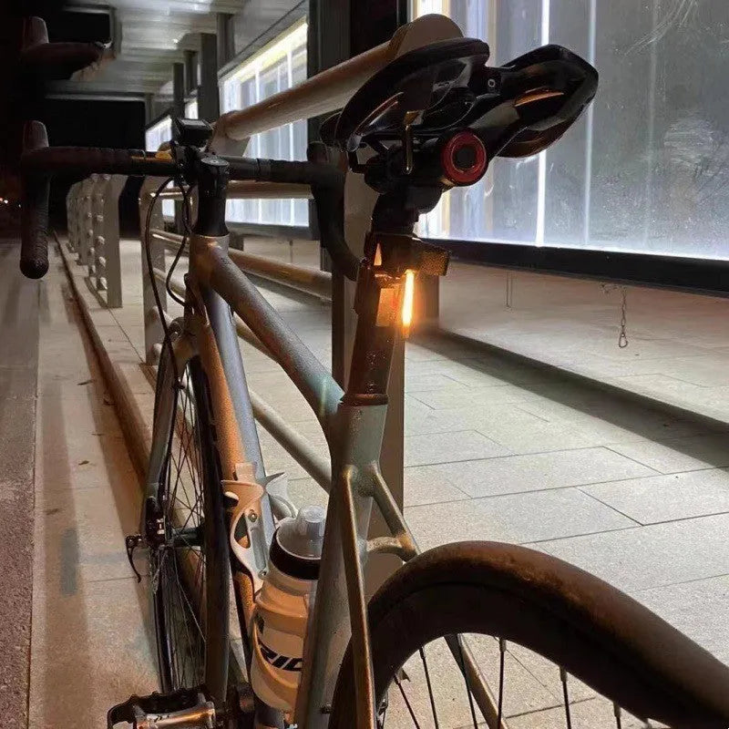 USB-charging waterproof bicycle taillight for night riding shown in blue, pink, red, white and yellow colour options.