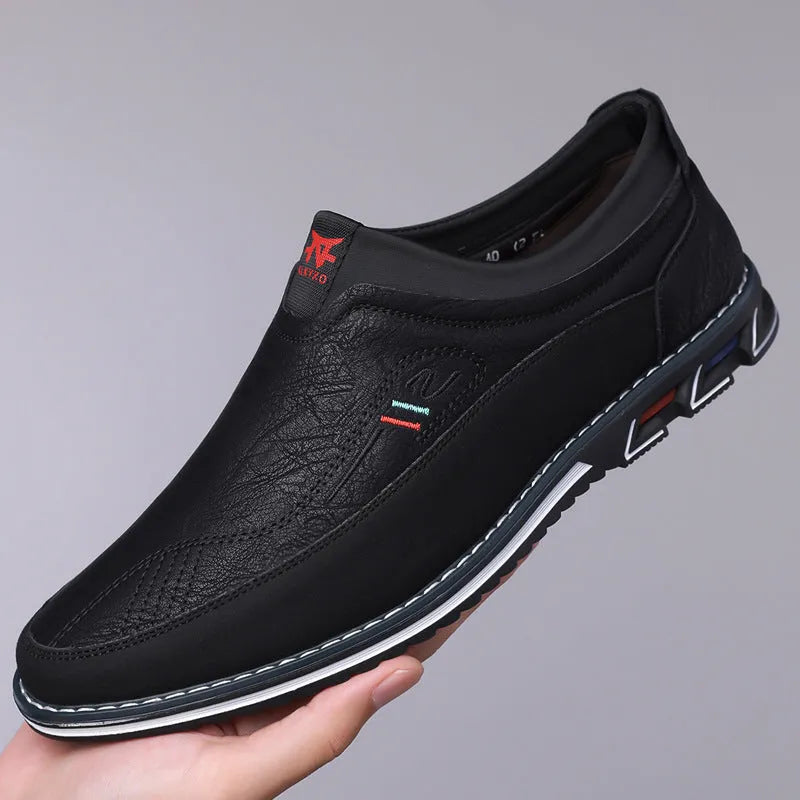Men's black leather casual shoes with a rubber sole and sewn detail on the fabric upper.