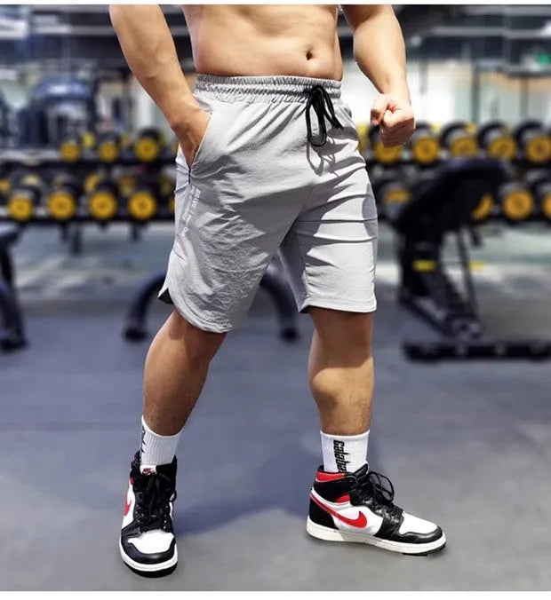 Man wearing thin black quick-dry running shorts made of nylon and spandex for sports.