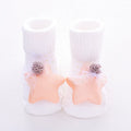 Pair of cotton baby socks in a pink colour with a star print design, shown flat.