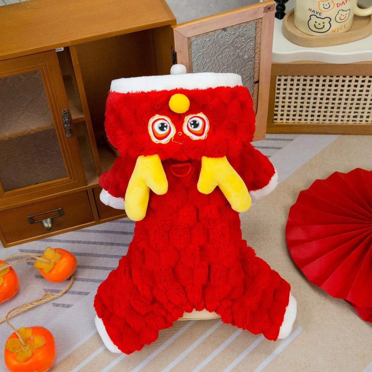 Red double-sided velvet pet jacket with a cartoon Little Dragon design for dogs and cats.