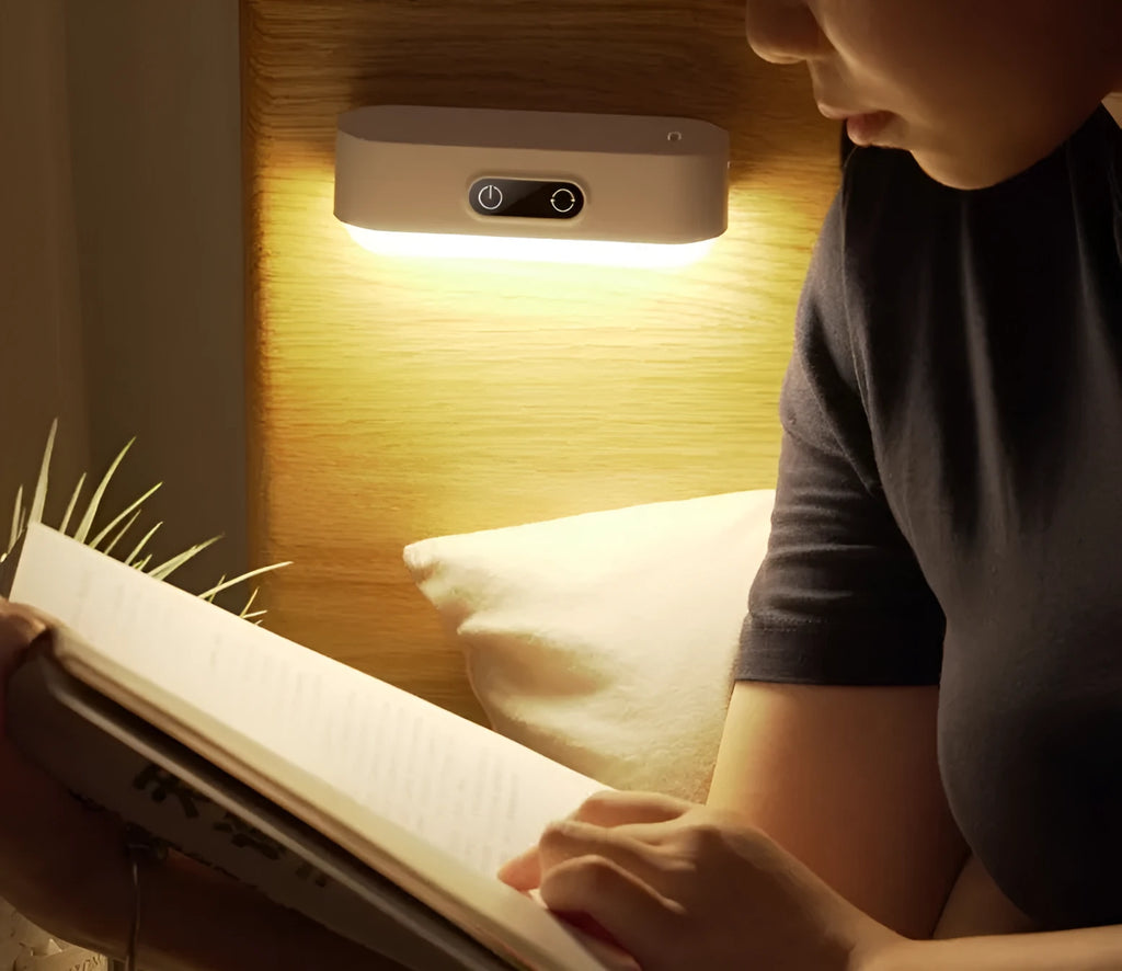 White magnetic USB rechargeable LED night light with touch controls mounted on a metal surface.