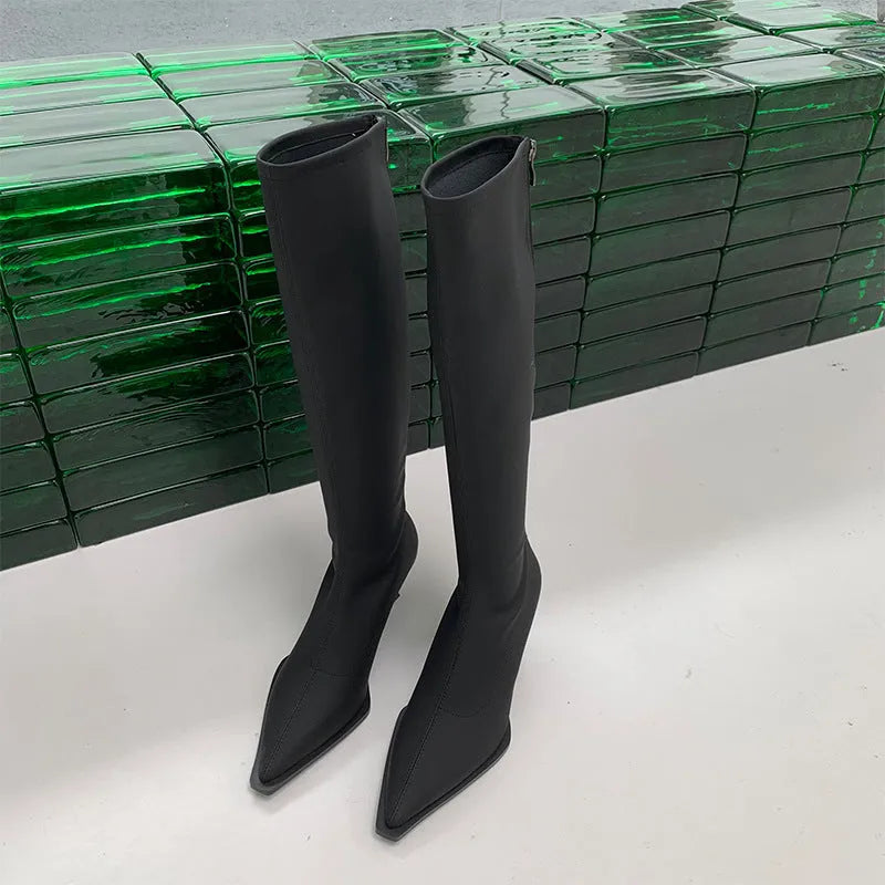 Women's pointed toe knee-high boots in black with a stiletto heel and a visible back zipper closure.