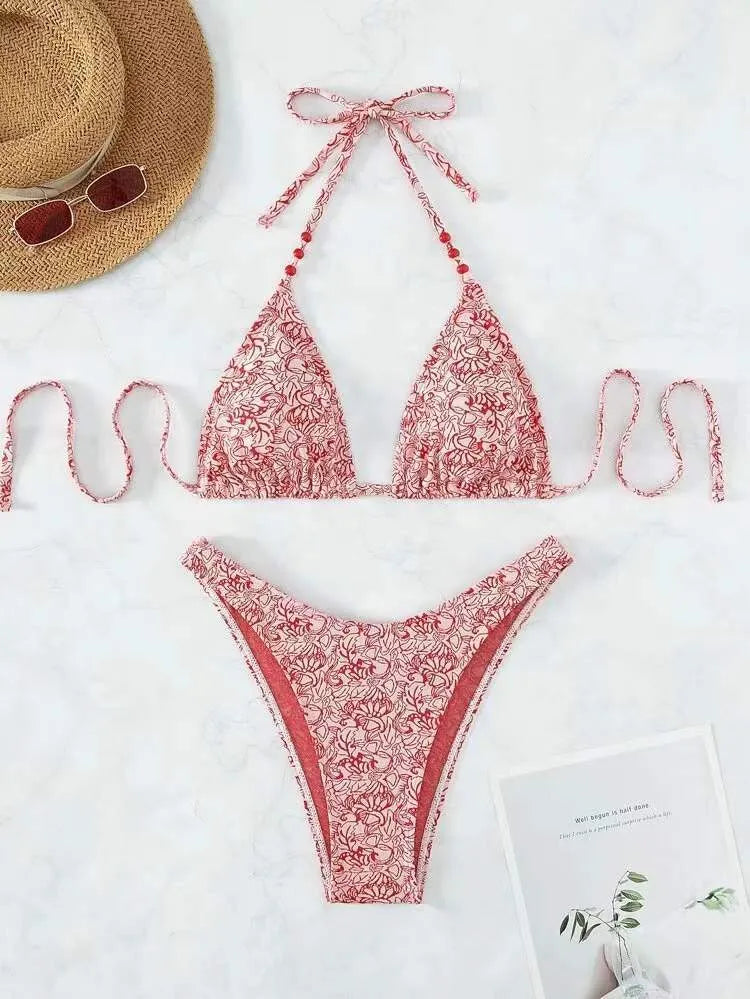 Women's flower pattern halter bikini top and shorts set in emerald green.