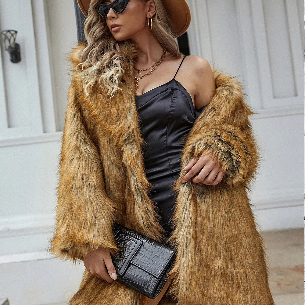 Yellow loose-fitting women's long faux fur coat on a hanger.