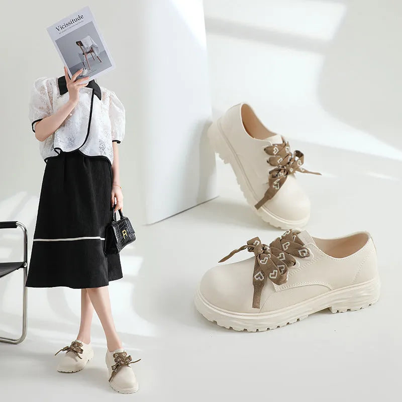 Women's mid-top rain boots with chunky low heel and round toe, available in ivory white, black, or khaki
