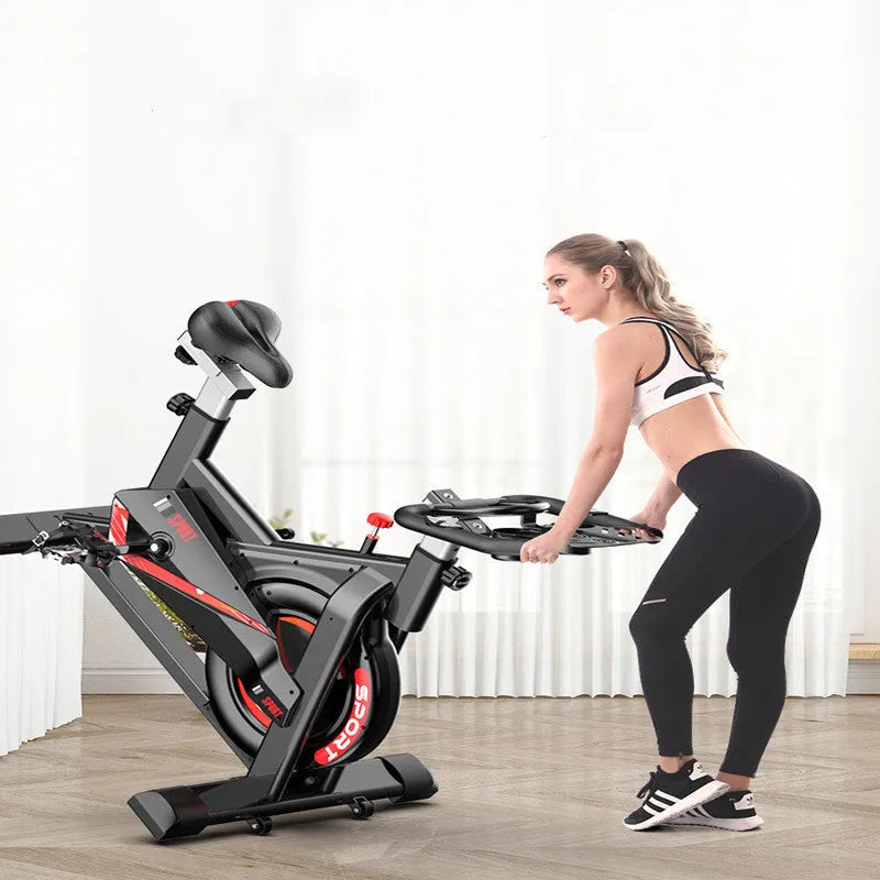 Black upright spinning bike with steel frame and console display for home cardio cycling