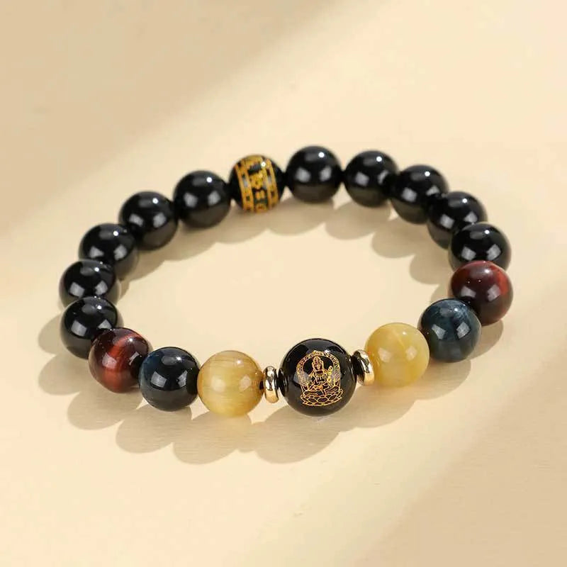 Handmade black agate beaded bracelet with gold, blue, and red tiger eye stones featuring Buddhist deity and zodiac animal motifs.