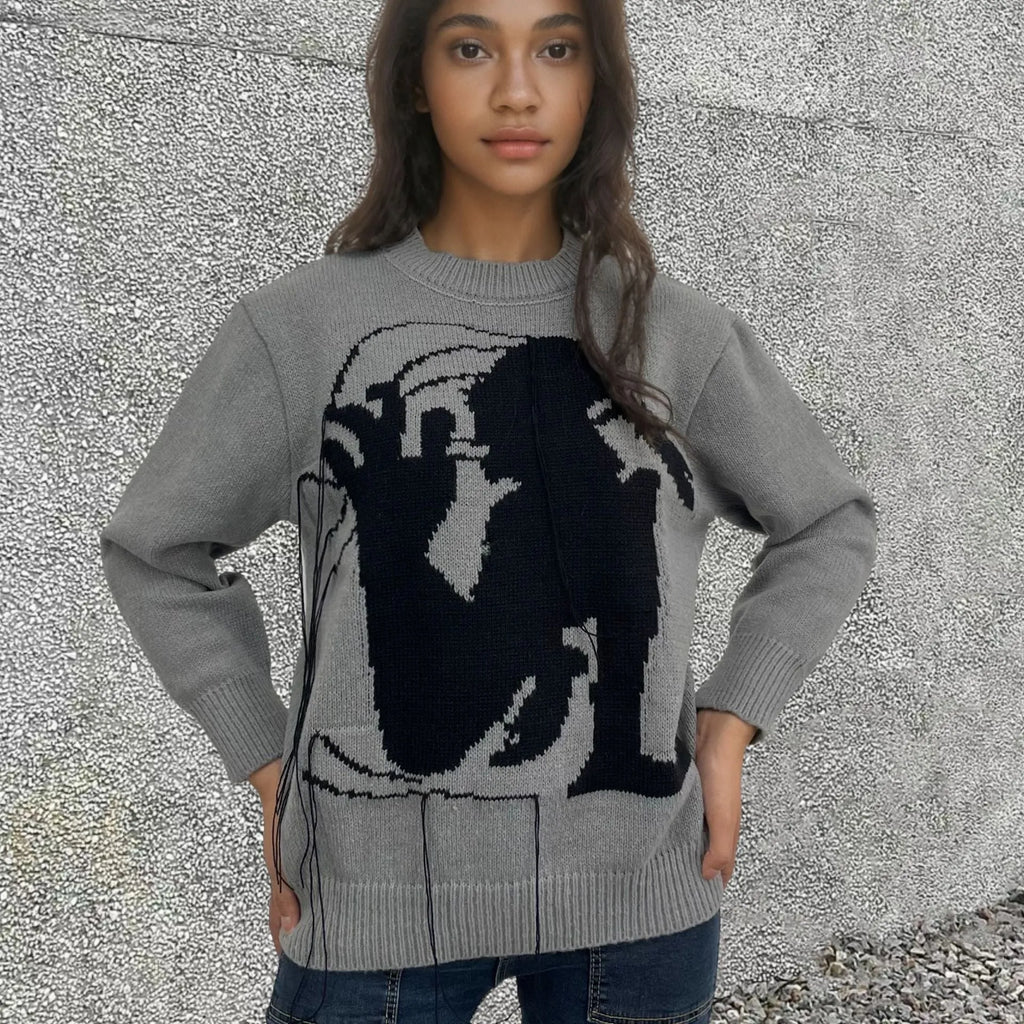 Grey women's loose alpaca wool sweater with tassel detailing and abstract pattern