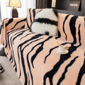 Zebra pattern flannel sofa cover with matching pillowcase on a sofa.