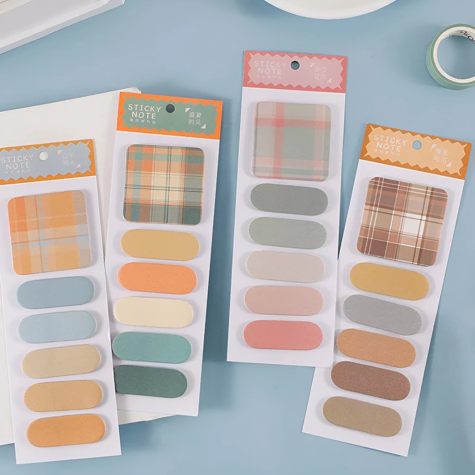 Colourful memo pad sticky notes showing eight different colour themes including plaid and solid designs.