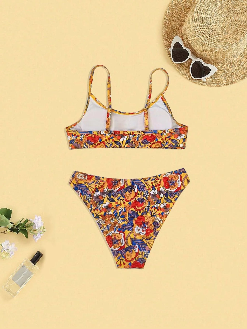 Plus size women's floral print strap bikini swimsuit set in brief style on a mannequin