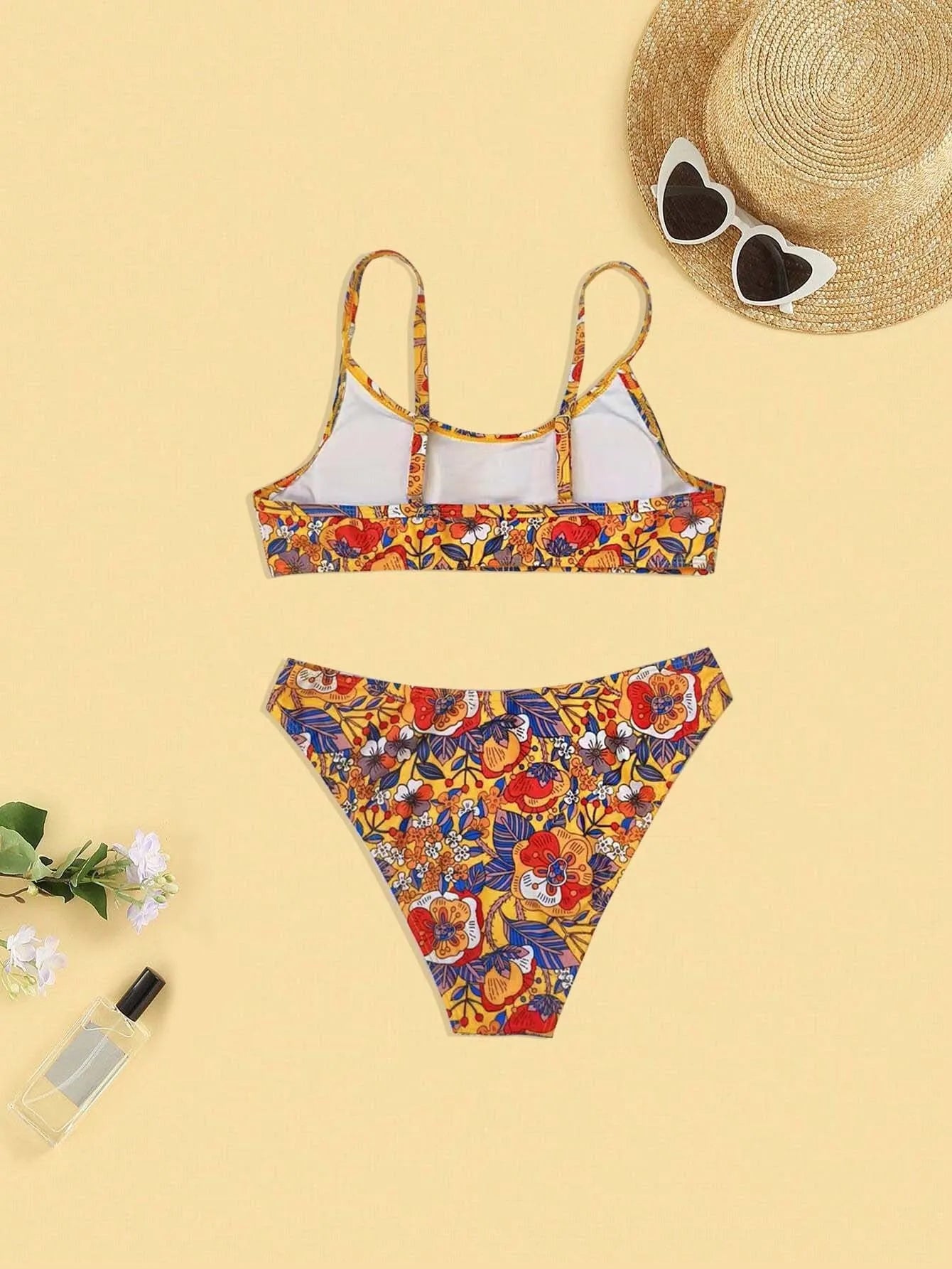 Plus size women's floral print strap bikini swimsuit set in brief style on a mannequin