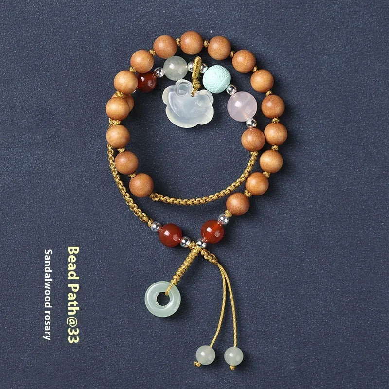 Hand-woven women's sandalwood bracelet with double-ring design and traditional gemstone accents