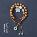 Hand-woven women's sandalwood bracelet with double-ring design and traditional gemstone accents