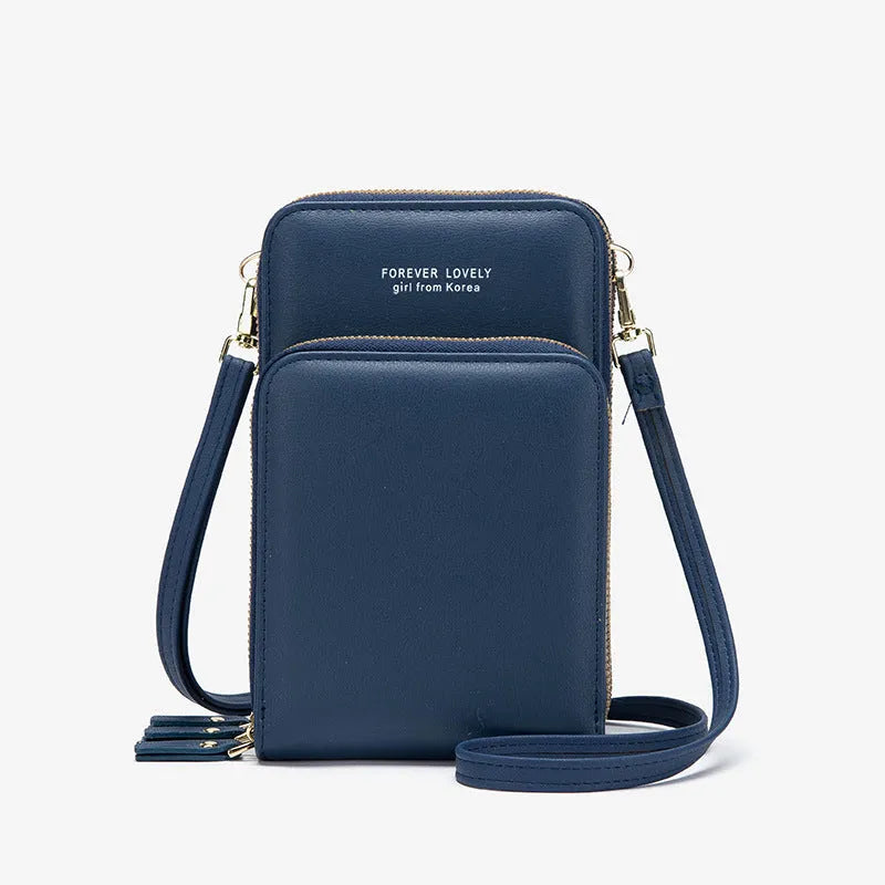 Green crossbody bag with tri-fold pockets and zipper closure on white background
