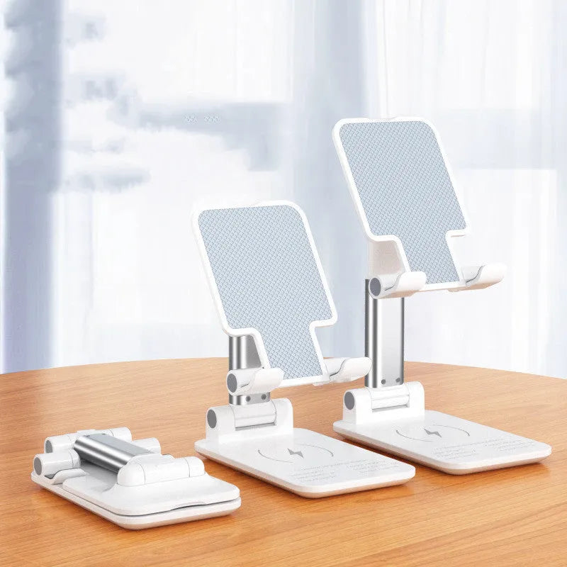Black and white desktop phone stand with wireless charging on a wooden desk.
