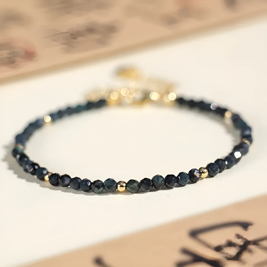 Women's blue tourmaline bracelet with 3mm beads and spacer bead design.