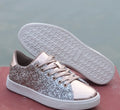 Women's black low-top casual shoes with sparkling sequinned upper and white laces.