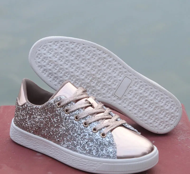 Women's black low-top casual shoes with sparkling sequinned upper and white laces.
