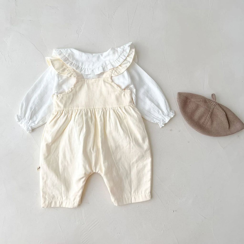Apricot coloured baby girl's cotton romper with white top, adjustable suspenders, and mid-waist trousers.