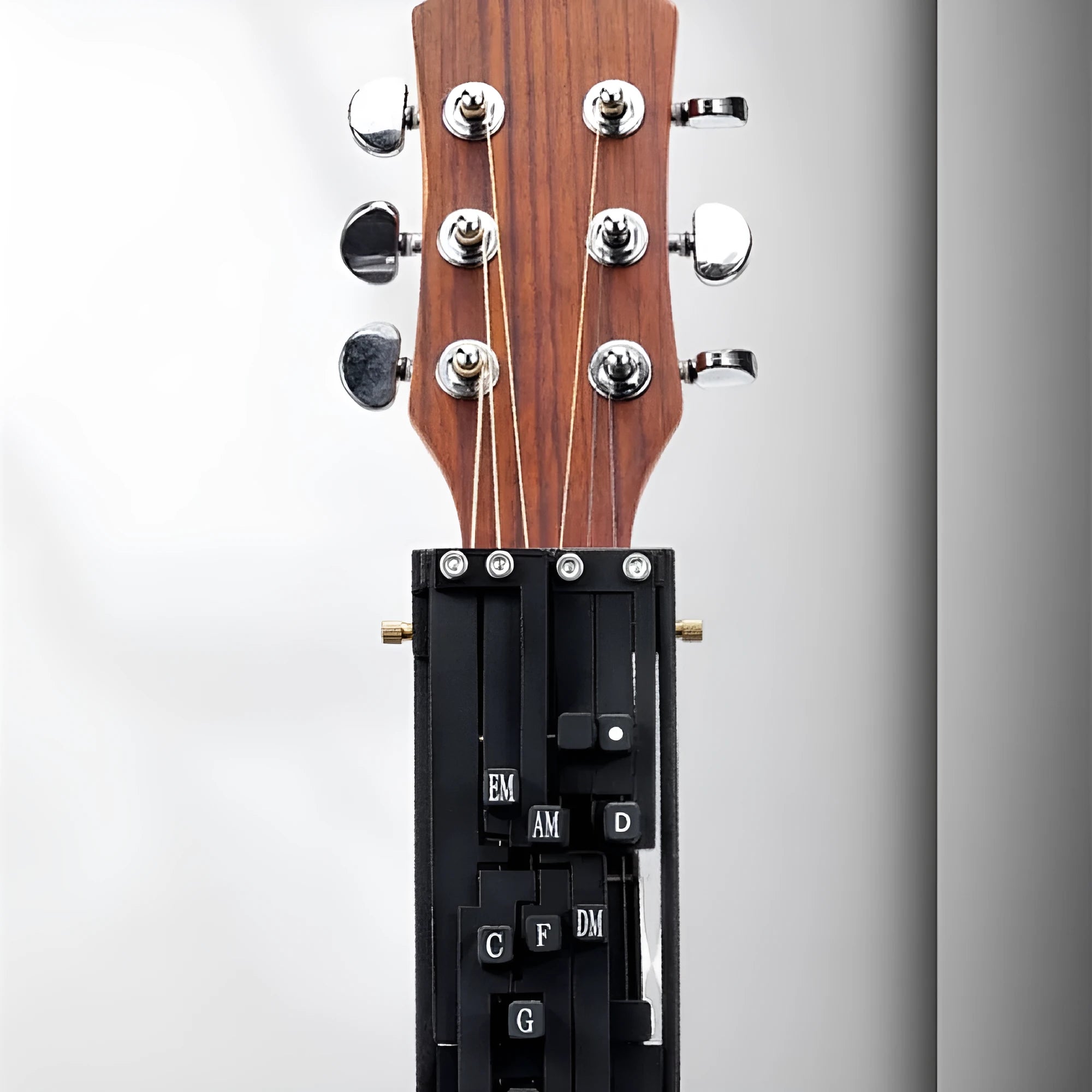 Black automatic chord practice device for folk guitar mounted on guitar neck