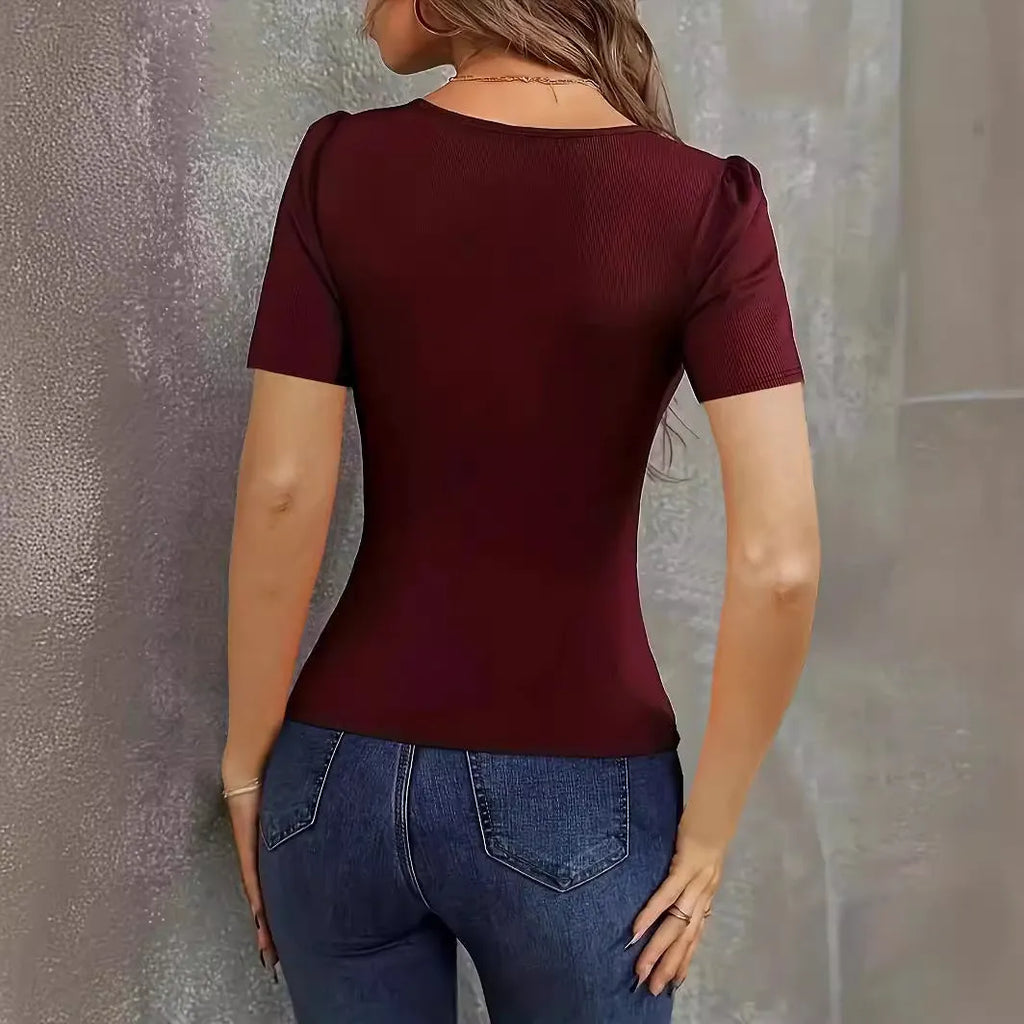 Women's wine red knitted slim fit short sleeve pullover top on a hanger.