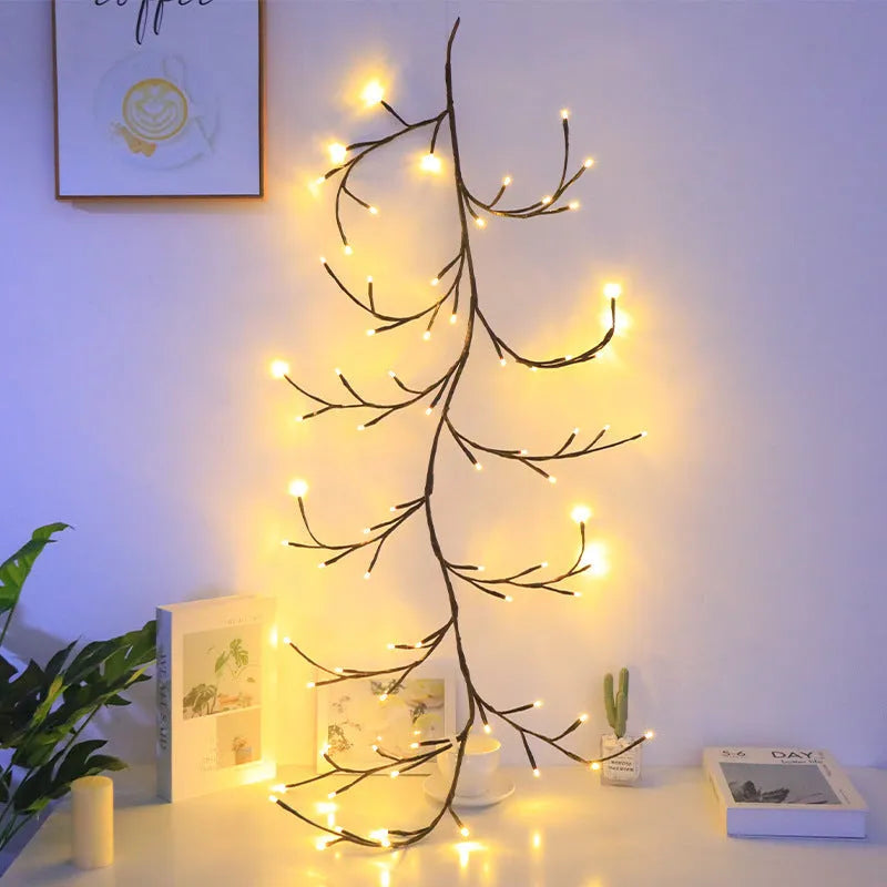 Tall flexible LED rattan tree lamp with colour-changing butterfly decorations lit up.