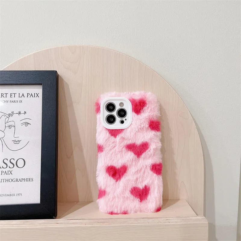 Pink silicone phone case with cartoon design for iPhone models 12, 13, 14, and 15.
