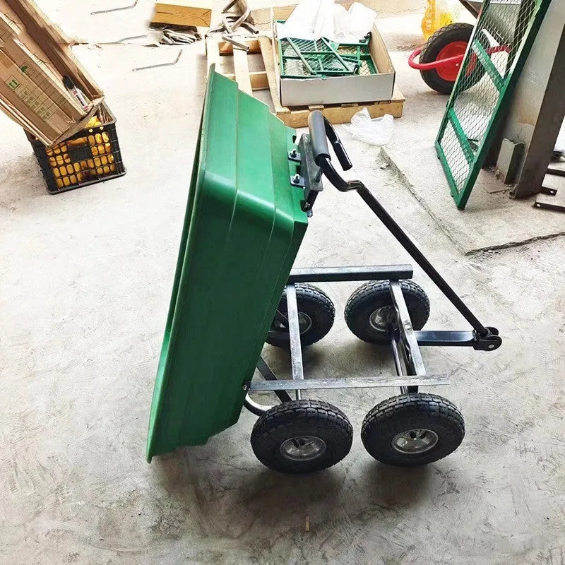 Green four-wheel plastic dump truck with a large cargo bed, shown on grass.