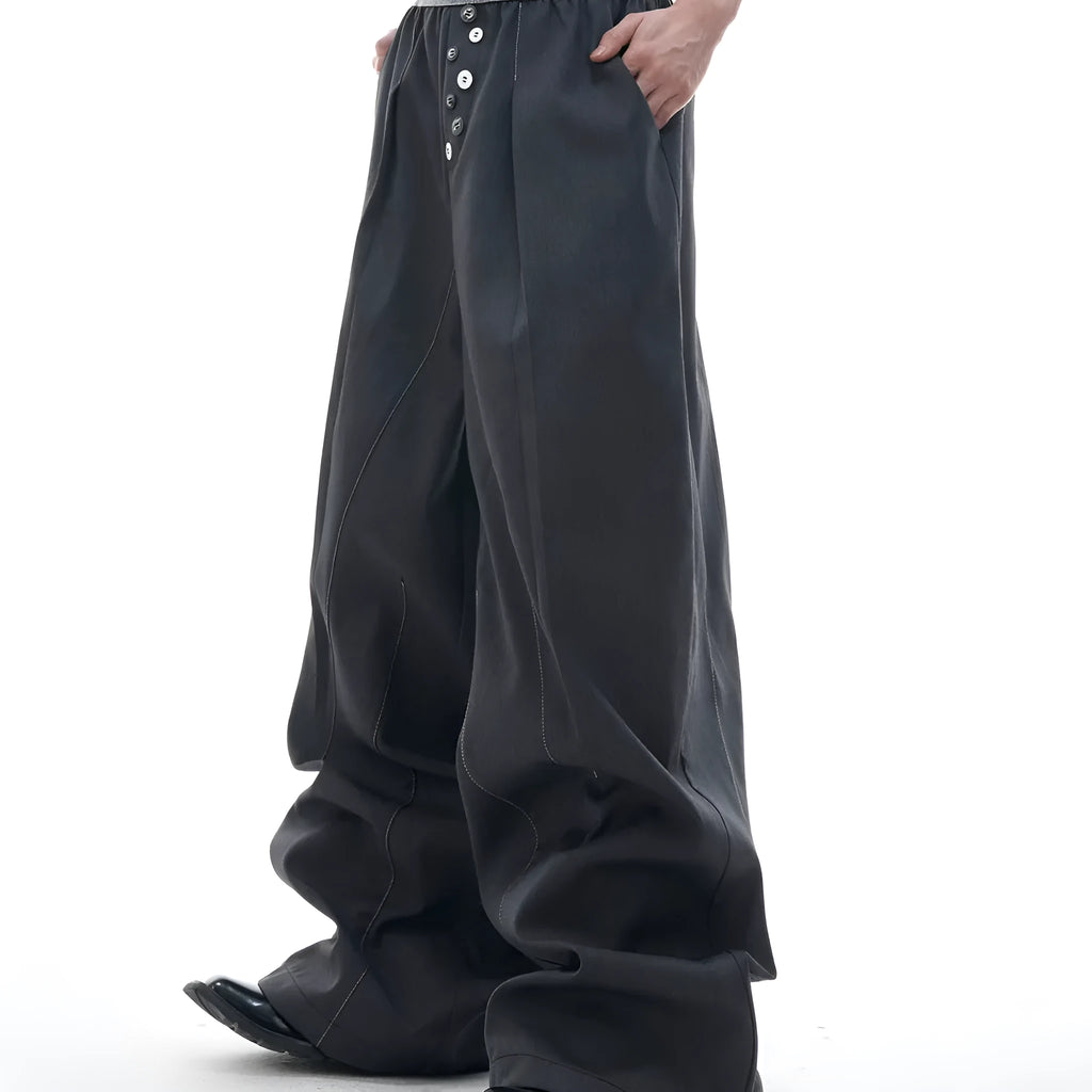 A pair of high-waisted straight-leg casual trousers in grey, showing the button-fly detail.
